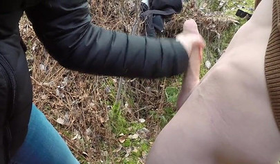 Playful teen catches a big dicked dude masturbating outdoors and helps him cum