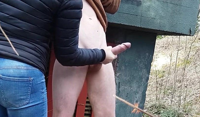 Playful teen catches a big dicked dude masturbating outdoors and helps him cum