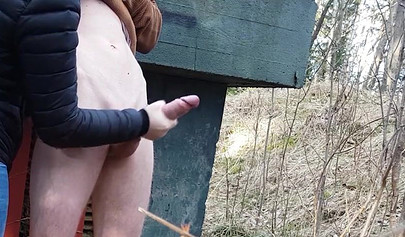 Playful teen catches a big dicked dude masturbating outdoors and helps him cum
