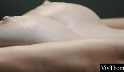 Attractive lesbian masseuse pleasing a big boobed teenage babe on the table