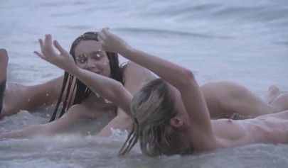 Four barely legal teens show off their slender bodies & holes on the sandy beach