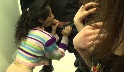 Two amateur girlfriends take care of a hard dick in the changing room