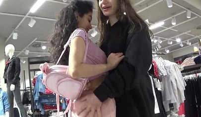 Two amateur girlfriends take care of a hard dick in the changing room