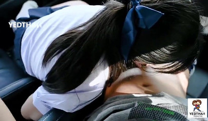 Thai chick in a school uniform fucking in a car