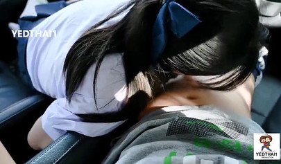 Thai chick in a school uniform fucking in a car