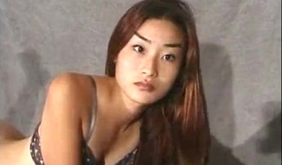 Petite Asian brunette teen fingering her pussy during photoshoot