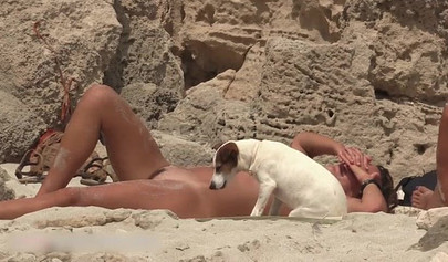 Beach spy catches a young brunette sunbathing fully naked