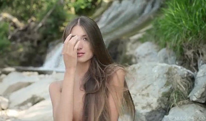 Skinny Russian teen model posing nude by waterfalls