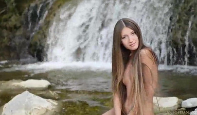 Skinny Russian teen model posing nude by waterfalls