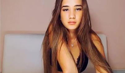 Beautiful brunette teen with big tits stripping and posing on cam