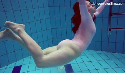 Redhead teen strips naked at the pool and shows her innocent body