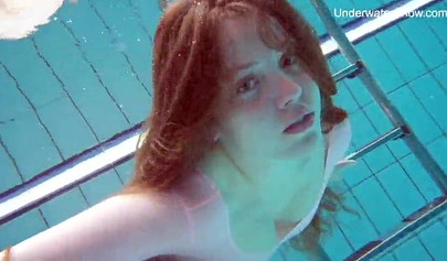 Redhead teen strips naked at the pool and shows her innocent body