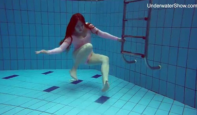 Redhead teen strips naked at the pool and shows her innocent body