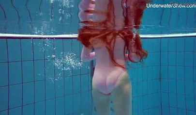 Redhead teen strips naked at the pool and shows her innocent body