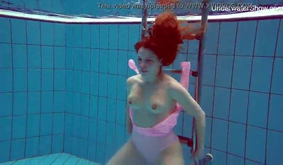 Redhead teen strips naked at the pool and shows her innocent body