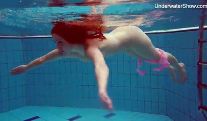 Redhead teen strips naked at the pool and shows her innocent body