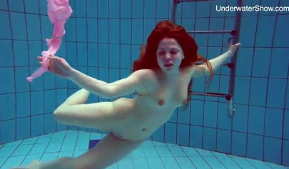Redhead teen strips naked at the pool and shows her innocent body