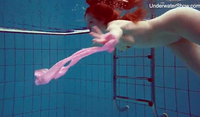 Redhead teen strips naked at the pool and shows her innocent body