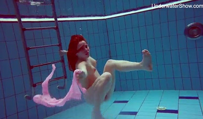 Redhead teen strips naked at the pool and shows her innocent body