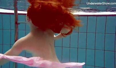 Redhead teen strips naked at the pool and shows her innocent body