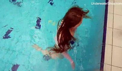 Redhead teen strips naked at the pool and shows her innocent body