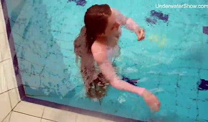 Redhead teen strips naked at the pool and shows her innocent body