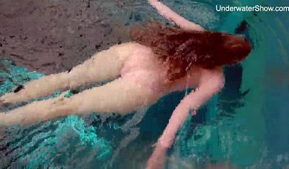 Redhead teen strips naked at the pool and shows her innocent body