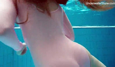 Redhead teen strips naked at the pool and shows her innocent body