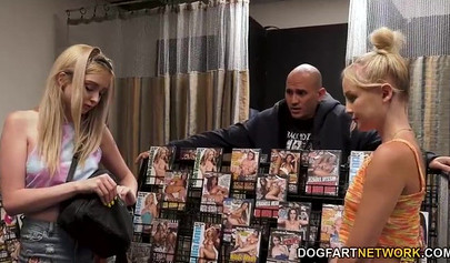 Two teen sluts suck and fuck BBCs at a gloryhole