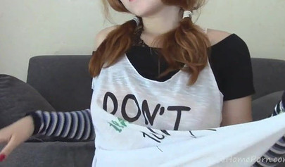 Ginger teen with big tits playing with her snatch on the sofa