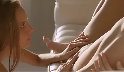 Two naked lesbian teens French kiss and fuck on the sofa