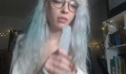 Teenage nerd shows her tiny tits and sucks a plastic dick