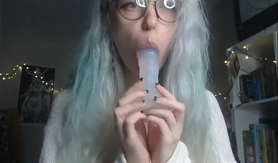 Teenage nerd shows her tiny tits and sucks a plastic dick