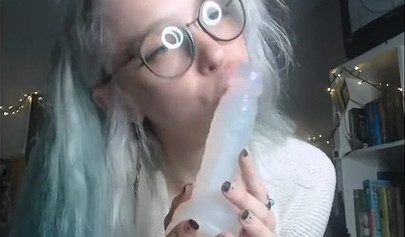 Teenage nerd shows her tiny tits and sucks a plastic dick