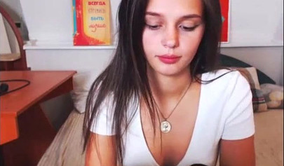 Adorable teen babe posing on camera in her sexy outfit