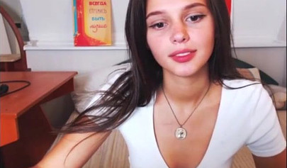 Adorable teen babe posing on camera in her sexy outfit