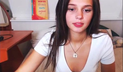 Adorable teen babe posing on camera in her sexy outfit