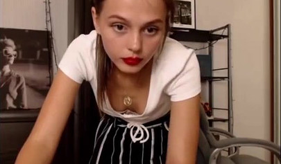 Adorable teen babe posing on camera in her sexy outfit