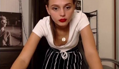 Adorable teen babe posing on camera in her sexy outfit