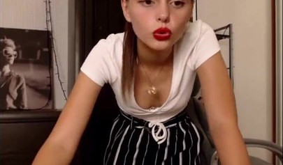 Adorable teen babe posing on camera in her sexy outfit