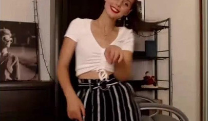 Adorable teen babe posing on camera in her sexy outfit