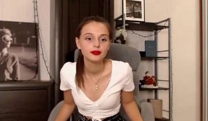 Adorable teen babe posing on camera in her sexy outfit