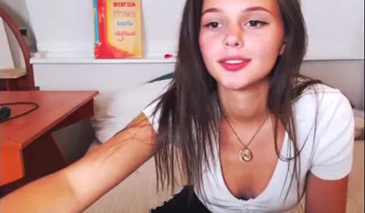 Adorable teen babe posing on camera in her sexy outfit