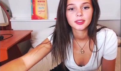 Adorable teen babe posing on camera in her sexy outfit