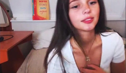 Adorable teen babe posing on camera in her sexy outfit