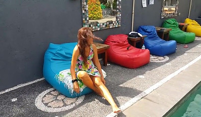 Pantyless teen in sexy summer dress flashes her trimmed pussy in public