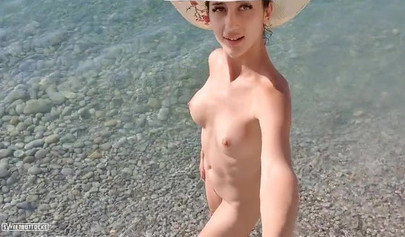 Beautiful teen with big tits posing nude on the beach