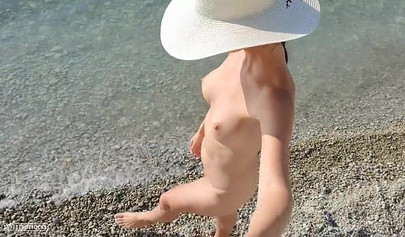 Beautiful teen with big tits posing nude on the beach