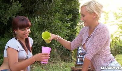 Three lesbian teens lick each other's feet outdoors