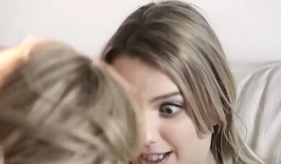 Mom Angela Sommers and her stepdaughter Kenna James scissor on the bed